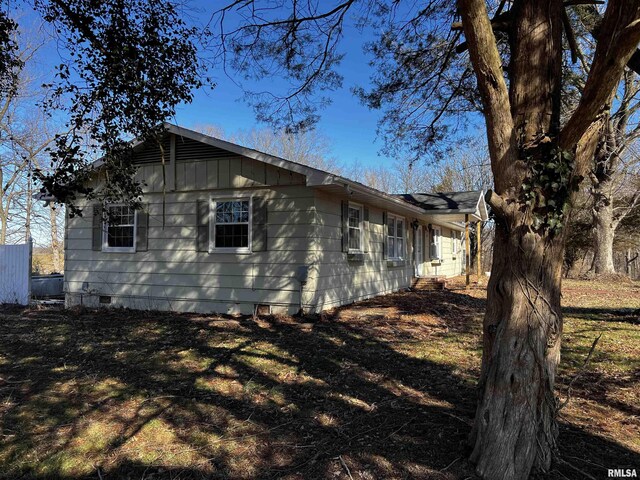 view of property exterior featuring crawl space and board and batten siding