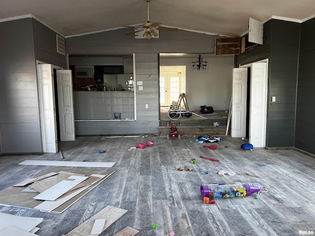 unfurnished bedroom featuring wood finished floors, visible vents, vaulted ceiling, french doors, and fridge