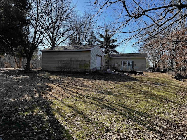 back of property featuring an outbuilding