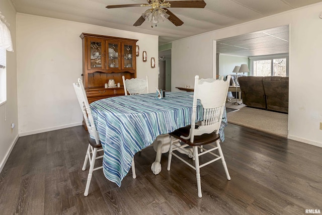 dining space featuring ceiling fan, baseboards, and wood finished floors