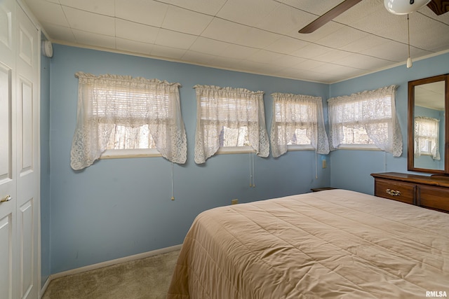 carpeted bedroom featuring baseboards