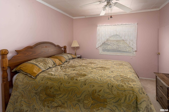 carpeted bedroom with ceiling fan, baseboards, and crown molding