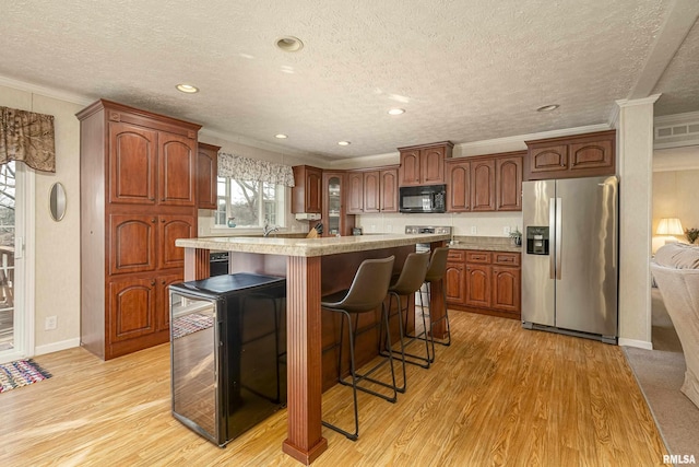 kitchen featuring wine cooler, black microwave, light countertops, and stainless steel fridge with ice dispenser