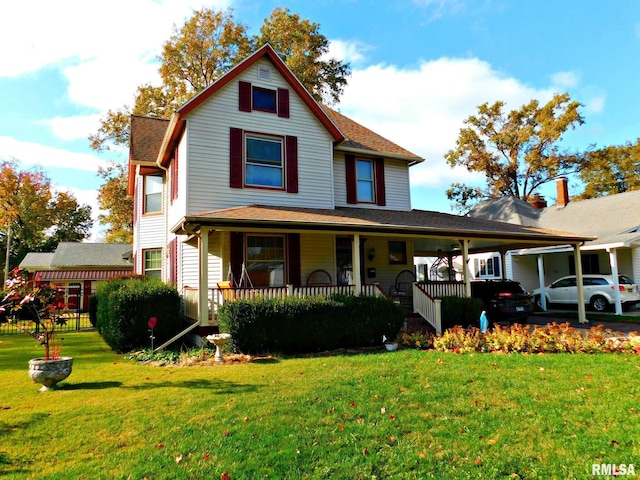 view of front facade featuring covered porch, a front lawn, and an attached carport