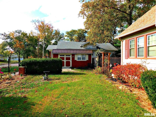 view of yard featuring fence and an outdoor structure