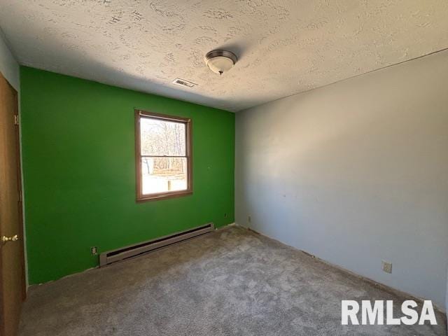 empty room with carpet, visible vents, a textured ceiling, and baseboard heating