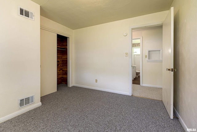 unfurnished bedroom featuring a closet, carpet, visible vents, and baseboards