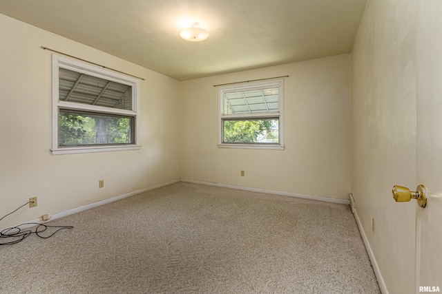 spare room with carpet flooring and baseboards