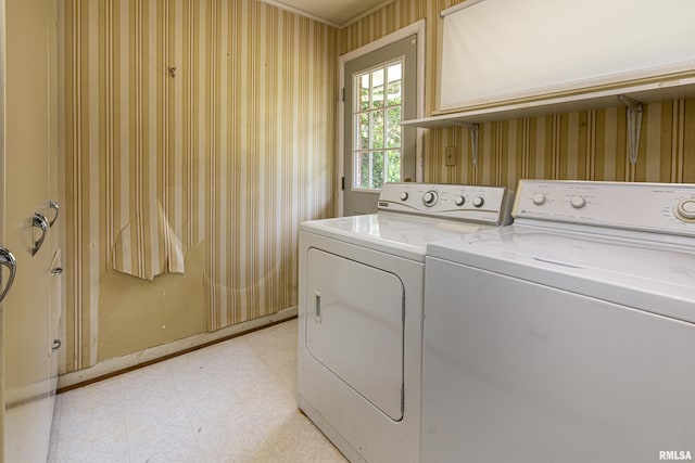 laundry room featuring laundry area, washing machine and clothes dryer, light floors, and wallpapered walls