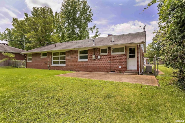 back of property featuring a patio, brick siding, fence, crawl space, and a lawn