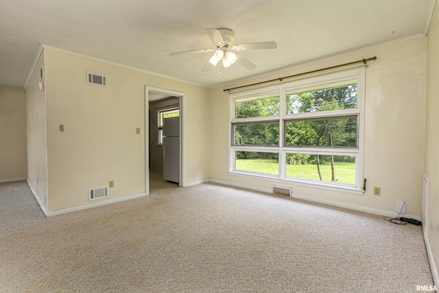 unfurnished room with ornamental molding and visible vents