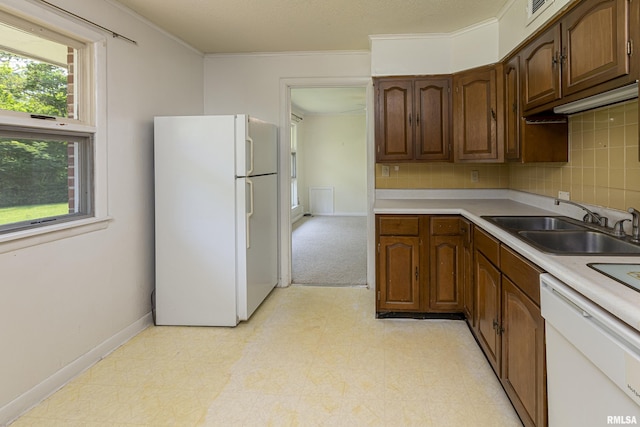 kitchen featuring light floors, white appliances, a sink, and light countertops