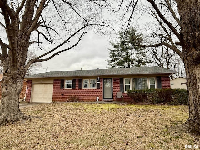 ranch-style house with a garage, concrete driveway, brick siding, and a front yard