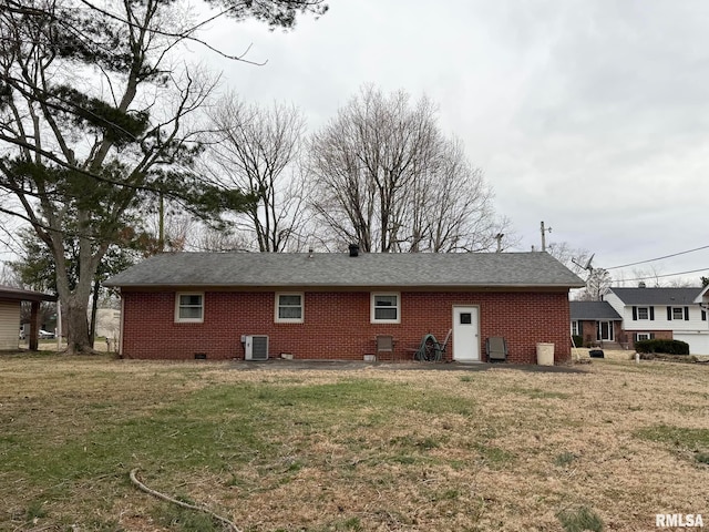 exterior space with a yard, central AC, brick siding, and crawl space