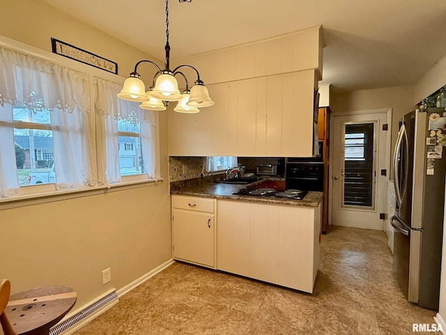 kitchen with dark countertops, visible vents, backsplash, a sink, and black appliances