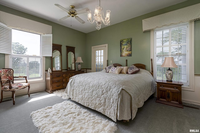 carpeted bedroom featuring multiple windows, baseboards, and a chandelier