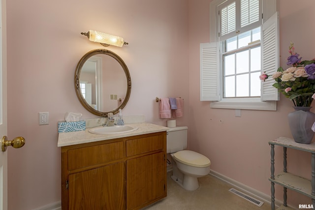 bathroom with toilet, baseboards, visible vents, and vanity