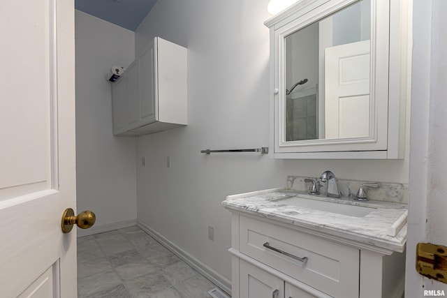 bathroom with marble finish floor, visible vents, baseboards, and vanity