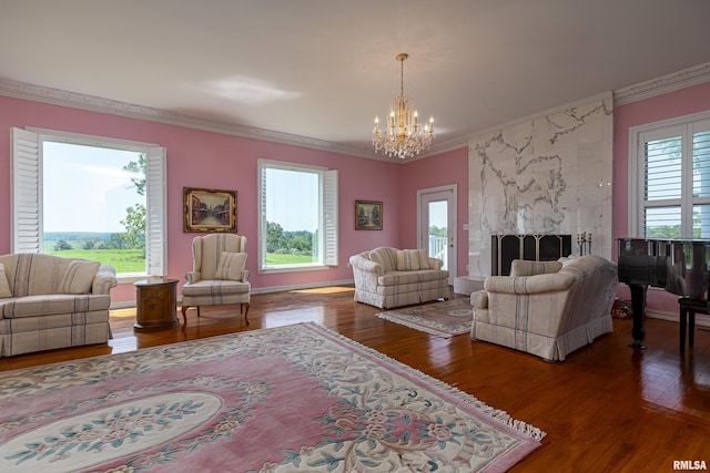 living room with a chandelier, crown molding, and wood finished floors