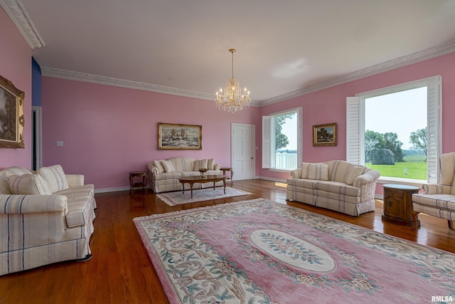 living room with a notable chandelier, crown molding, baseboards, and wood finished floors