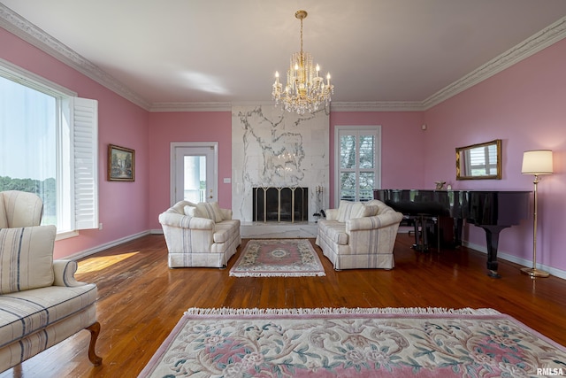 living room featuring baseboards, a fireplace, wood finished floors, and crown molding