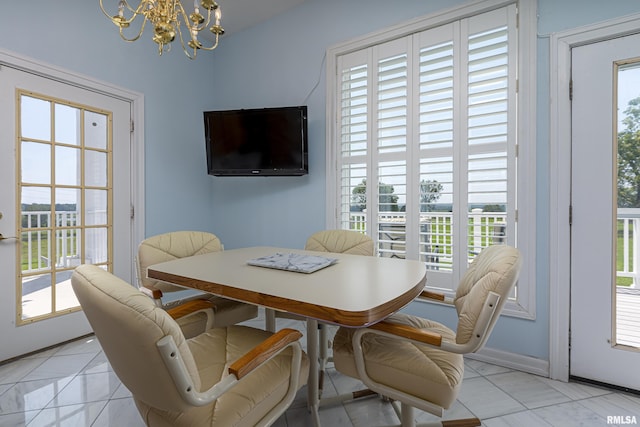 dining space with a chandelier and light tile patterned flooring