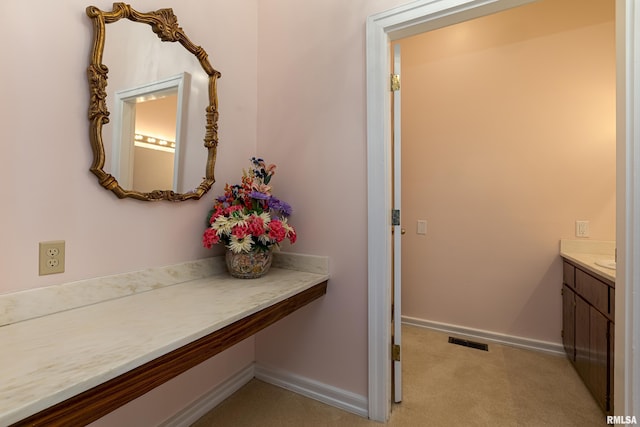 bathroom with visible vents, vanity, and baseboards