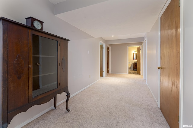 corridor featuring carpet floors and baseboards