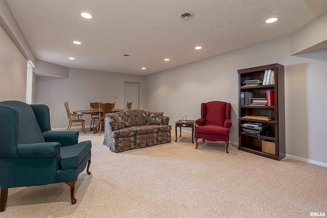 living room with a textured ceiling, recessed lighting, carpet floors, visible vents, and baseboards