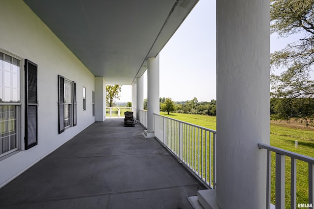 exterior space with a balcony and a rural view