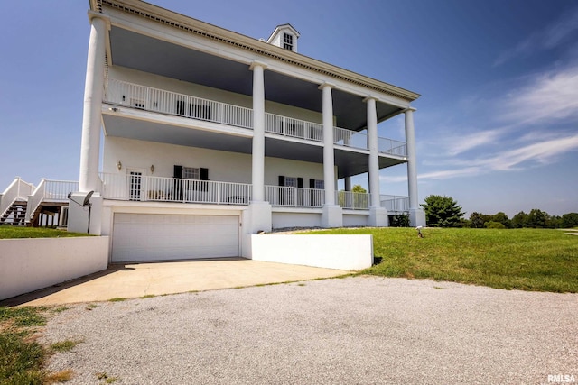 view of front of house featuring driveway, an attached garage, and stucco siding