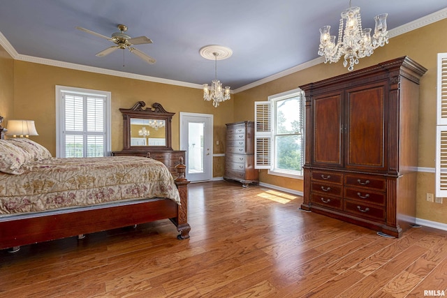 bedroom featuring a chandelier, crown molding, baseboards, and wood finished floors