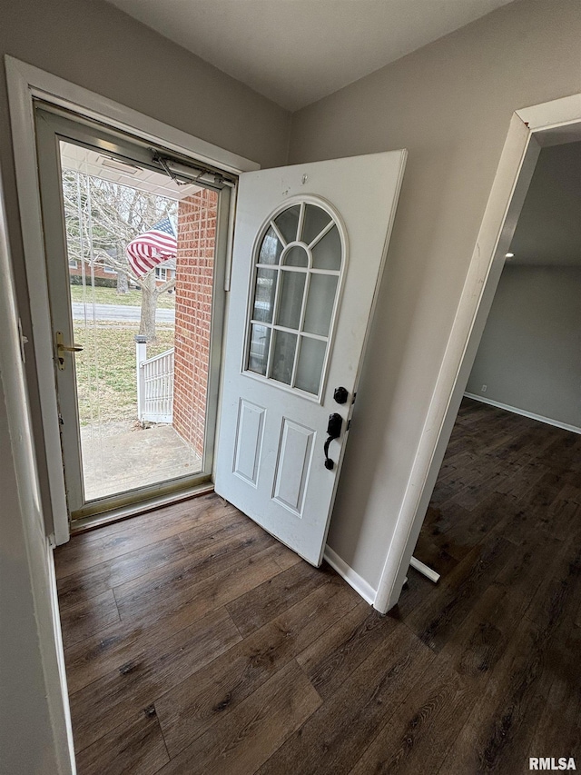 foyer with baseboards and dark wood-style flooring