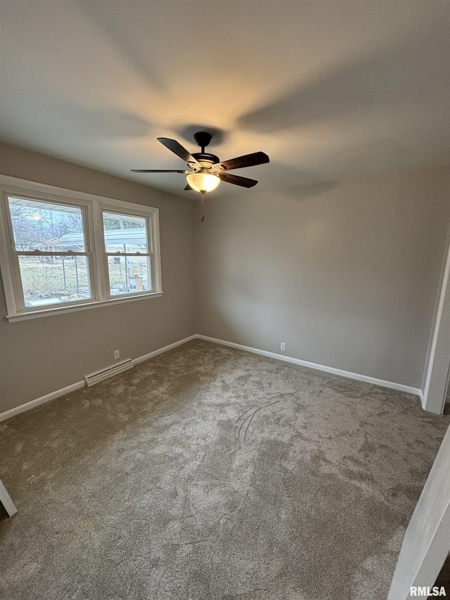 carpeted spare room featuring visible vents, ceiling fan, and baseboards