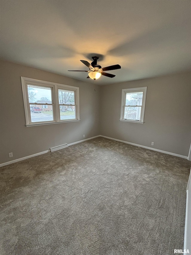 unfurnished room featuring a ceiling fan, carpet flooring, visible vents, and baseboards