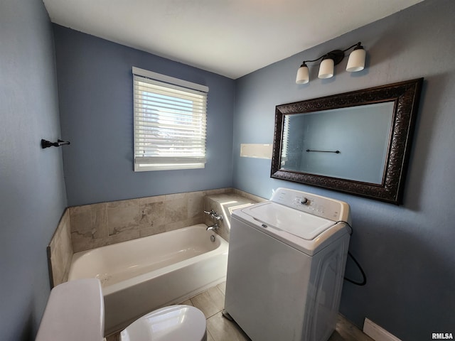 full bath with toilet, a garden tub, washer / clothes dryer, and vanity