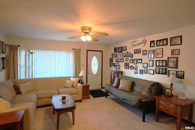 carpeted living area featuring ceiling fan