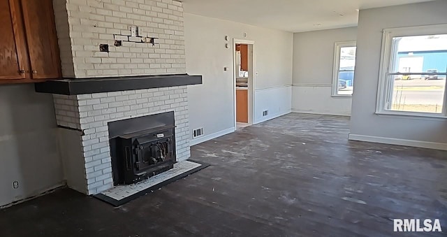 unfurnished living room featuring visible vents and baseboards