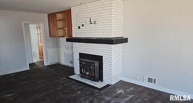 unfurnished living room featuring baseboards and visible vents