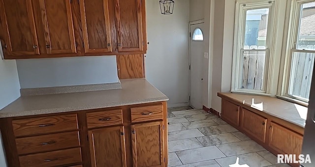 kitchen featuring brown cabinets and light countertops