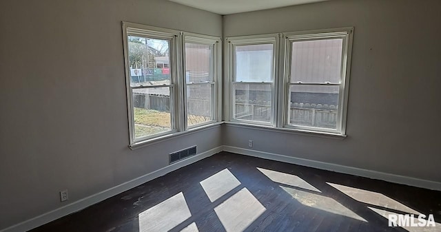 empty room featuring visible vents and baseboards