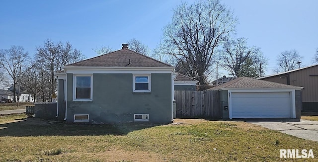 view of side of home featuring concrete driveway, stucco siding, a lawn, and fence