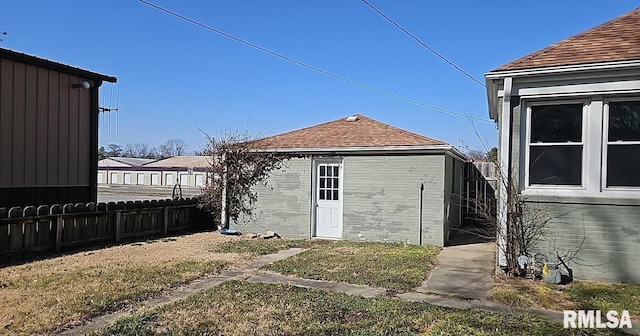 view of outdoor structure with an outbuilding and fence