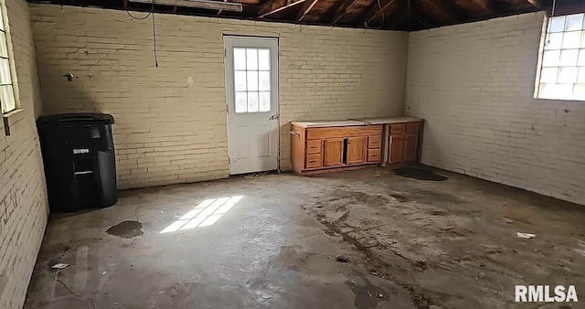 interior space featuring brick wall