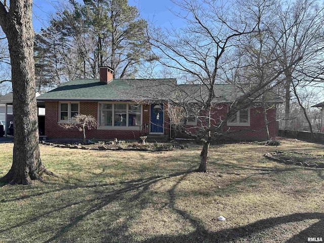 single story home featuring a shingled roof, a chimney, a front lawn, and brick siding