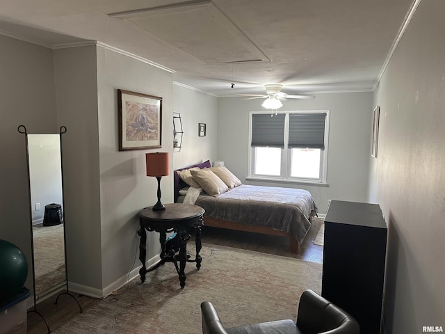 carpeted bedroom featuring attic access, crown molding, and a ceiling fan