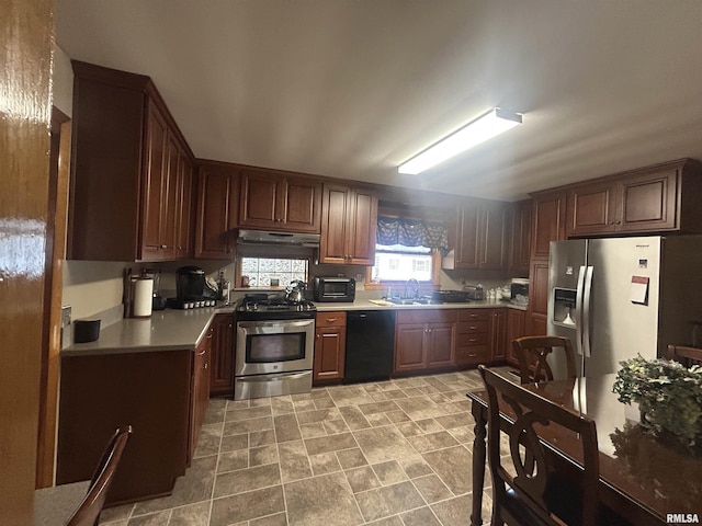 kitchen featuring appliances with stainless steel finishes, light countertops, a sink, and under cabinet range hood