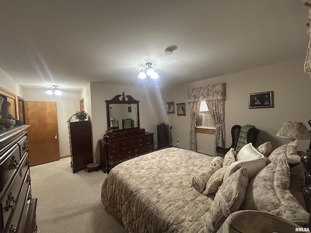 bedroom featuring light carpet