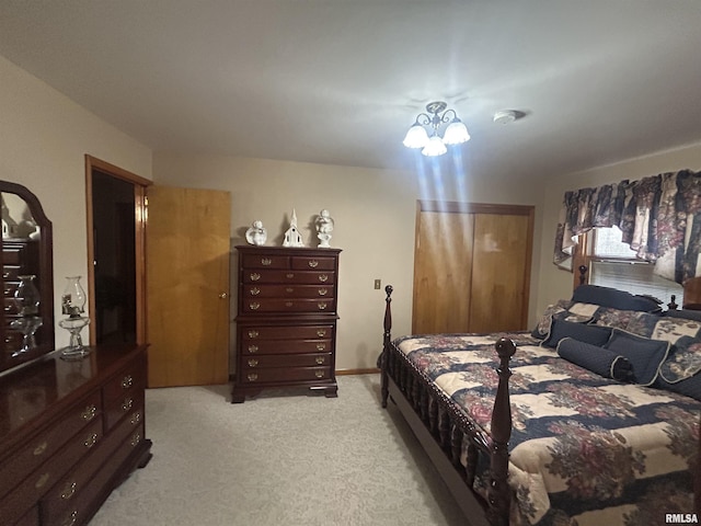 bedroom featuring an inviting chandelier and light colored carpet