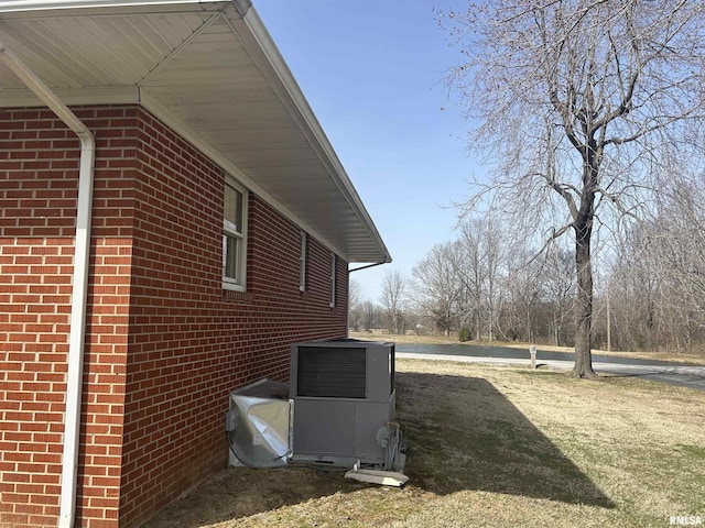 view of home's exterior featuring brick siding and central air condition unit